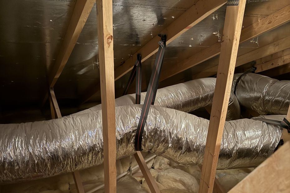 Attic ductwork with silver flex duct and fiberglass insulation in a Las Vegas, NV home