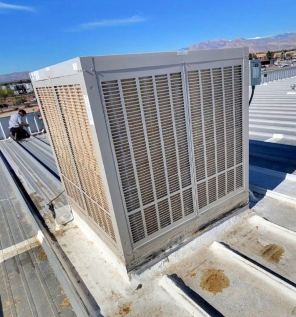 Large commercial rooftop evaporative cooler on a Las Vegas, NV commercial building with desert and Spring Mountains in the background
