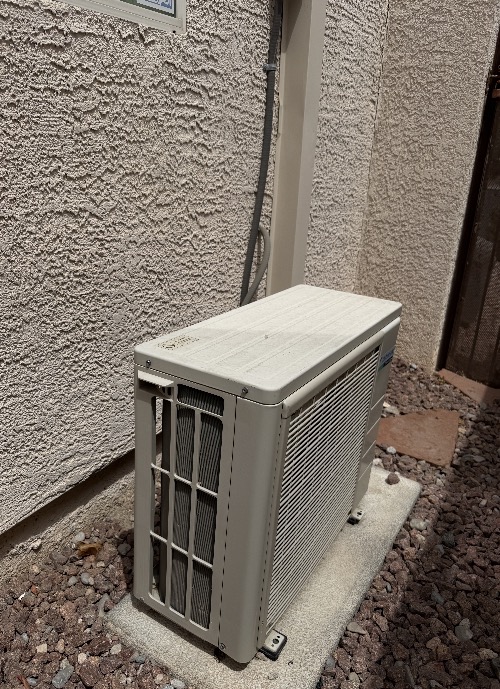 Outdoor ductless mini split condenser mounted on a pad beside a Las Vegas, Nevada home