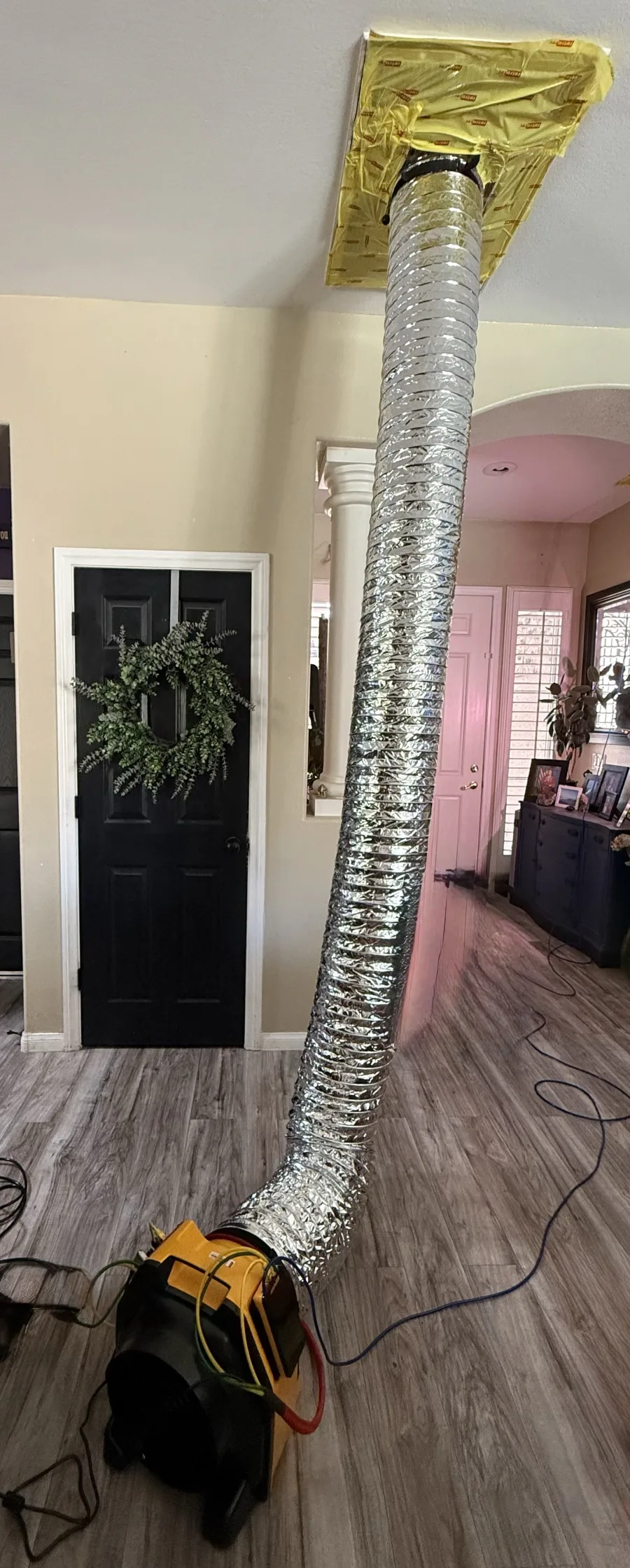 Duct leakage testing fan sealed to a ceiling register during a residential test in Las Vegas, Nevada